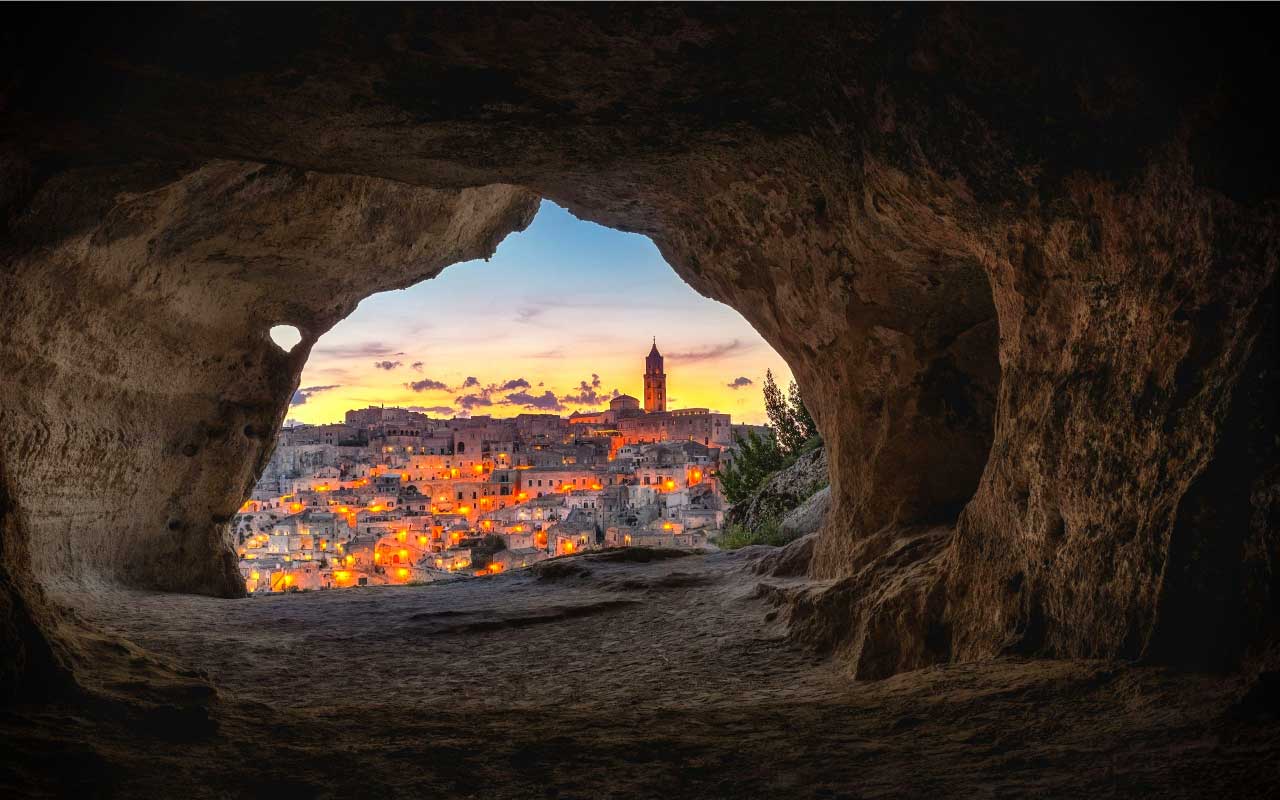 洞穴的嘴在黄昏时俯瞰着一个城市。